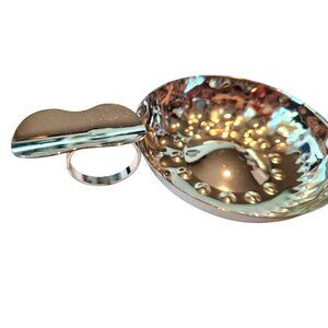 Sommeliers tasting cup A shallow, silver tastevin traditionally for winemakers